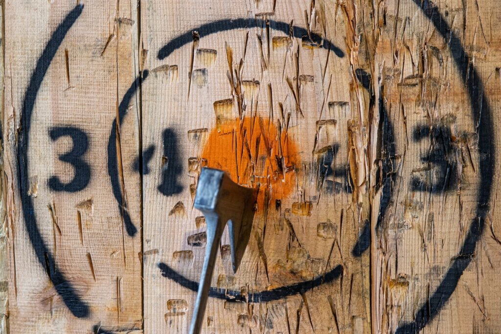 Axe throwing target with axe in center bullseye